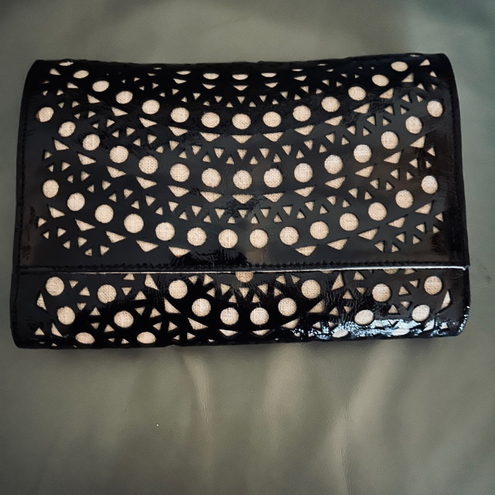 Sondra Roberts Perforated black patent leather clutch with linen underlay. NWT